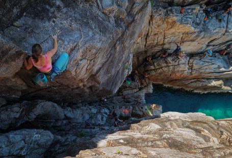 people-rock-climbing-on-sea-shore