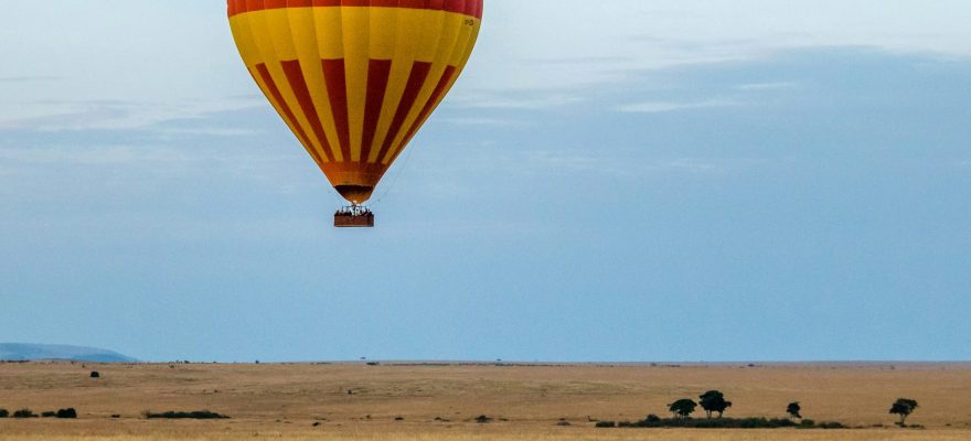 red-and-yellow-hot-air-balloon-over-field-with-zebras